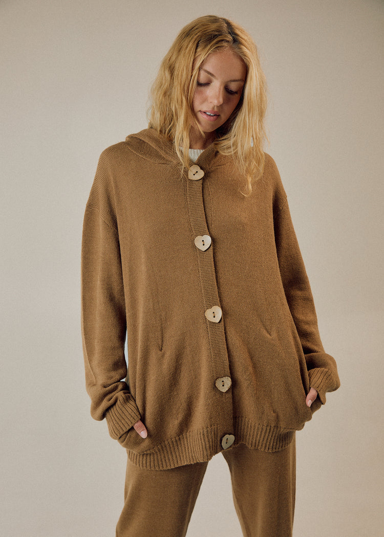 Model in camel cardigan